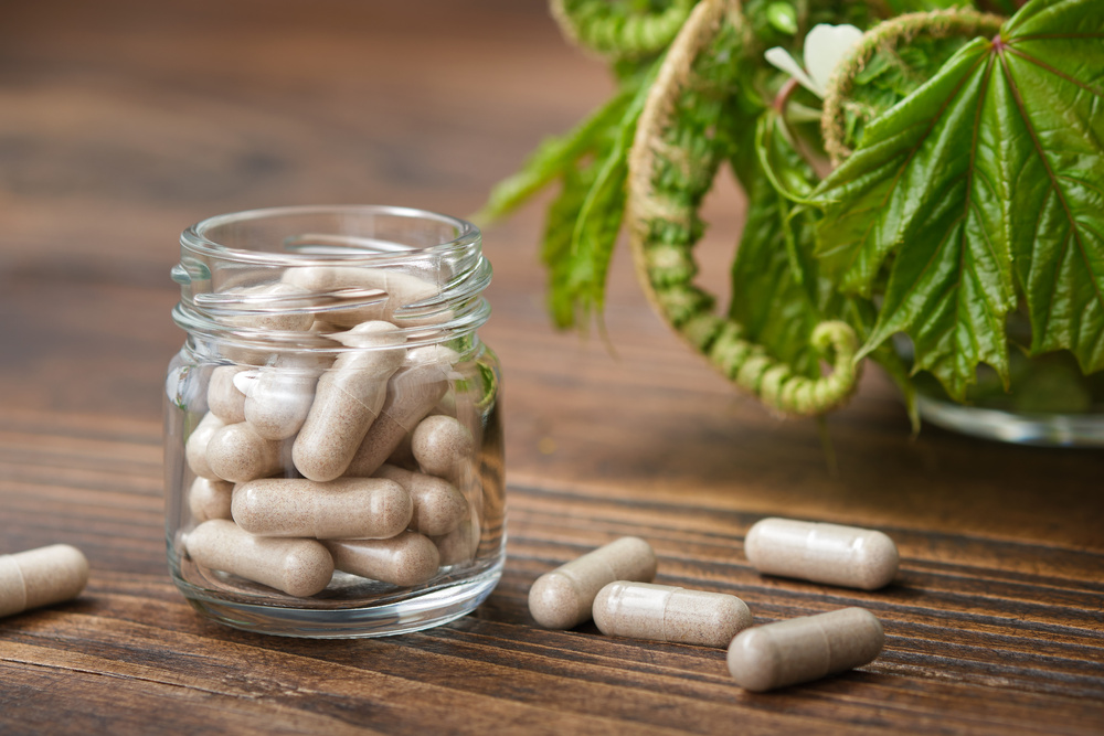 Herbal pills, jar of natural tablets. Medicinal healing herb